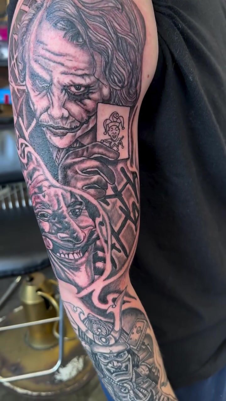 Black and gray Joker sleeve tattoo with playing cards