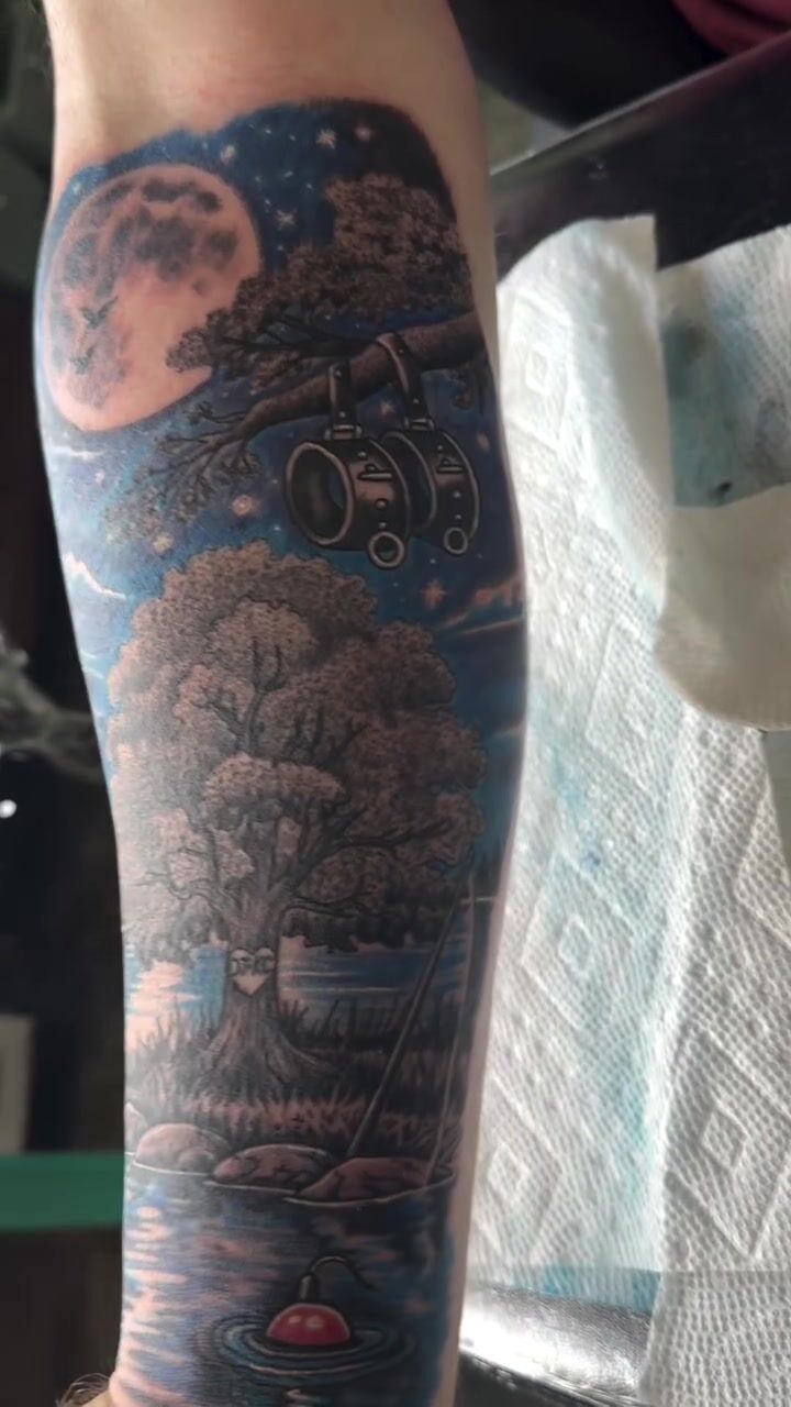 Black and gray night forest and full moon sleeve tattoo on a leg
